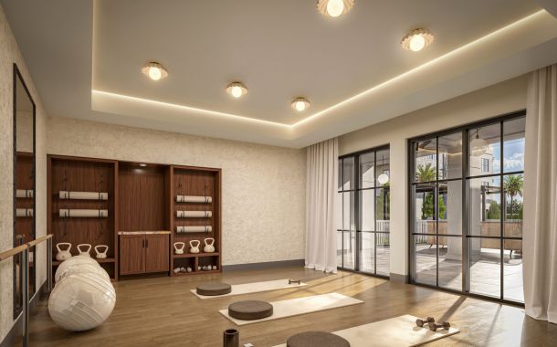 Woman doing yoga in bright sun lit room